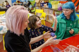 Child making slime at Incredible Kids play session