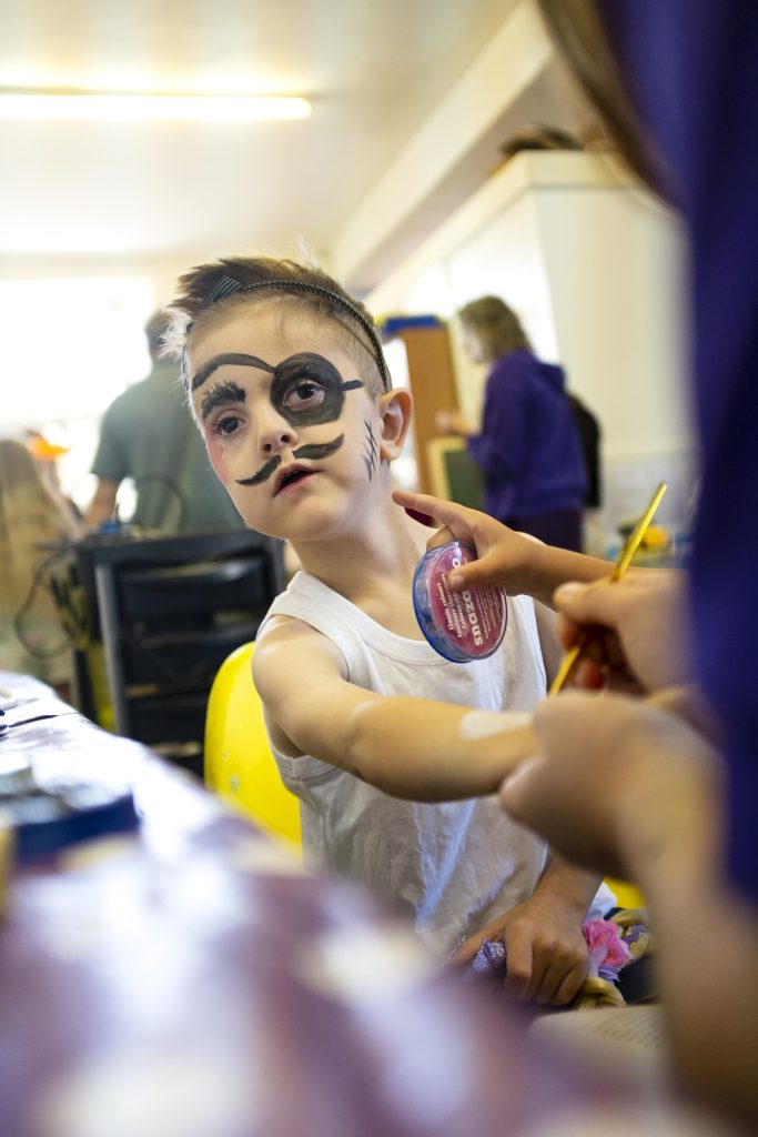 Young white boy with pirate eye patch and moustache faint paint